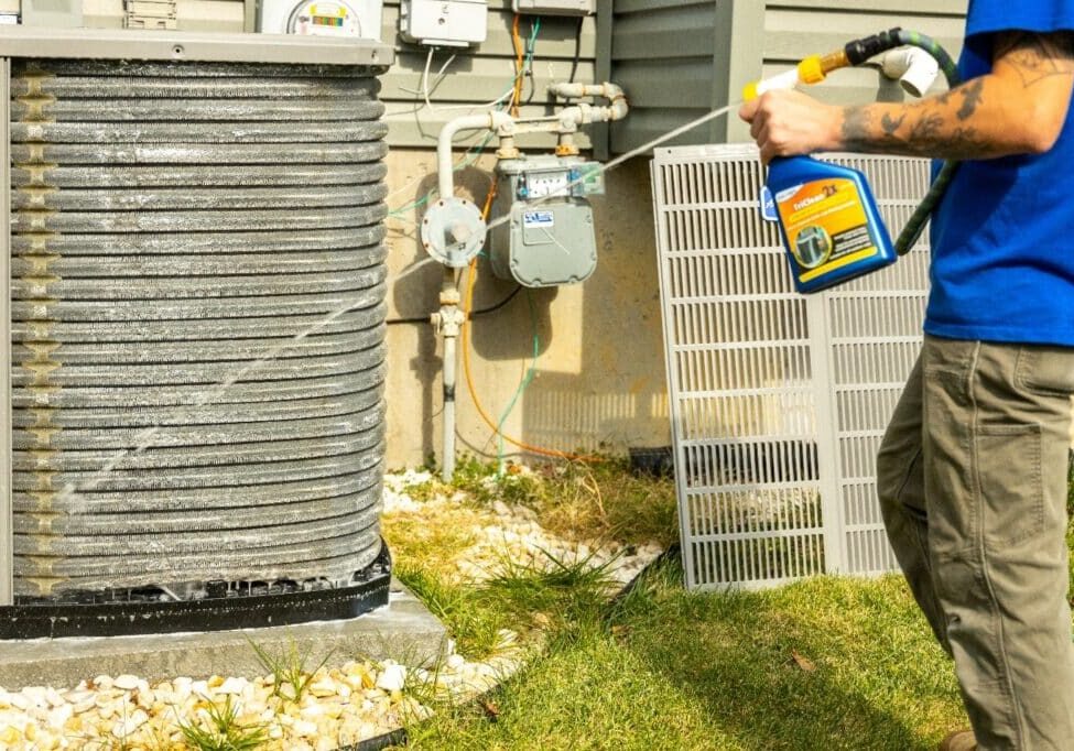 Air conditioner maintenance by Hoock’s Heating & Cooling service technician.